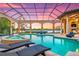 Enclosed pool area with spa, lounge chairs, and sunset view at 8376 Catamaran Cir, Lakewood Ranch, FL 34202