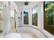 Spa-like shower with multiple shower heads and marble finishes at 8376 Catamaran Cir, Lakewood Ranch, FL 34202