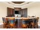 Custom wet bar with granite countertop and seating at 8376 Catamaran Cir, Lakewood Ranch, FL 34202