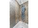 Spa-like bathroom with rainfall shower head and marble tile at 900 Cove Cay Dr # 2B, Clearwater, FL 33760