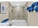 Clean bathroom with a shower/tub combo and marble-tiled walls at 900 Cove Cay Dr # 2B, Clearwater, FL 33760