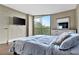 Bright bedroom with large window, hardwood floors, and dresser at 900 Cove Cay Dr # 2B, Clearwater, FL 33760