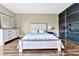Bright bedroom with a white wooden bed frame, dresser, and large mirror at 900 Cove Cay Dr # 2B, Clearwater, FL 33760