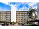 Three-story condo building with parking and lush landscaping at 900 Cove Cay Dr # 2B, Clearwater, FL 33760