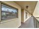 Exterior hallway with carpeted floors and windows with blinds at 900 Cove Cay Dr # 2B, Clearwater, FL 33760