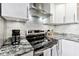 Modern kitchen featuring stainless steel appliances and granite countertops at 900 Cove Cay Dr # 2B, Clearwater, FL 33760