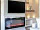 Living room with built-in electric fireplace and mounted TV at 900 Cove Cay Dr # 2B, Clearwater, FL 33760