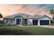 Two-story home with gray roof and blue exterior at 9024 Evelyn Rd, Englewood, FL 34224