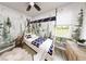 Cozy bedroom with teepee bed, mountain mural, and wood floors at 9024 Evelyn Rd, Englewood, FL 34224