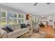 Light and airy living room with hardwood floors and sliding doors at 919 Hickory Hill Ct, Palm Harbor, FL 34684