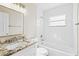 Bathroom with white vanity, granite countertop, and a tub/shower combo at 9201 40Th N Way, Pinellas Park, FL 33782