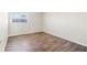 Empty bedroom with wood-look laminate flooring and neutral walls at 9201 40Th N Way, Pinellas Park, FL 33782