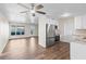Kitchen with white cabinets, stainless steel appliances, and wood-look flooring at 9201 40Th N Way, Pinellas Park, FL 33782