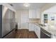 Modern kitchen featuring white shaker cabinets, granite countertops, and stainless steel appliances at 9201 40Th N Way, Pinellas Park, FL 33782