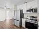 Kitchen with white shaker cabinets, stainless steel appliances, and granite countertops at 9201 40Th N Way, Pinellas Park, FL 33782