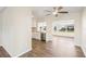 View of the kitchen and dining area with wood-look flooring and large windows at 9201 40Th N Way, Pinellas Park, FL 33782