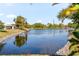 Community lake with a rock-lined shore and mature trees at 9201 40Th N Way, Pinellas Park, FL 33782