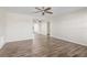 Spacious living room with wood-look flooring, neutral walls, and ceiling fan at 9201 40Th N Way, Pinellas Park, FL 33782