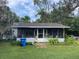 Ranch style home with screened porch and yard at 9920 Harney Rd, Thonotosassa, FL 33592