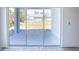 View of backyard through sliding glass doors at 3430 Sarto Ln, Rotonda West, FL 33947