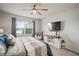 Main bedroom with a king bed, a sitting chair, and a large window at 1003 Tidal Rock Ave, Ruskin, FL 33570