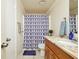 Bathroom featuring granite countertop, wood cabinets, and shower at 10111 Lazy Creek Ct, Tampa, FL 33615