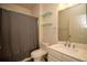 Bathroom features a toilet, a sink and vanity, a shower and glass shelves at 10764 70Th Ave # 6107, Seminole, FL 33772