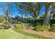 Spacious backyard with a basketball court, mature trees, and lush landscaping at 11114 Lake Sassa Dr, Thonotosassa, FL 33592