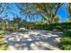 Large backyard with a basketball court under shade trees at 11114 Lake Sassa Dr, Thonotosassa, FL 33592