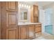 Bathroom with wood vanity, mirror, and additional storage at 11114 Lake Sassa Dr, Thonotosassa, FL 33592