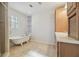 Bathroom with clawfoot tub, shower, and built-in vanity at 11114 Lake Sassa Dr, Thonotosassa, FL 33592
