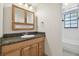 Bathroom with granite countertop, wood cabinets and a sink at 11114 Lake Sassa Dr, Thonotosassa, FL 33592