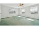Bedroom with green carpet, ceiling fan and two windows at 11114 Lake Sassa Dr, Thonotosassa, FL 33592