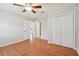 Bedroom with hardwood floors, ceiling fan and double door closet at 11114 Lake Sassa Dr, Thonotosassa, FL 33592