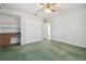 Bedroom with green carpet, ceiling fan, built-in desk and double closet at 11114 Lake Sassa Dr, Thonotosassa, FL 33592