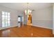 Dining room with hardwood floors, a chandelier, and access to the kitchen at 11114 Lake Sassa Dr, Thonotosassa, FL 33592