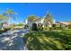 House exterior showcasing a driveway, garage, and well-maintained landscaping at 11114 Lake Sassa Dr, Thonotosassa, FL 33592