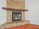 Stone fireplace with wood mantel in living room at 11114 Lake Sassa Dr, Thonotosassa, FL 33592