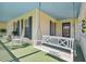 Inviting front porch featuring a porch swing and rocking chairs, perfect for relaxation at 11114 Lake Sassa Dr, Thonotosassa, FL 33592