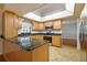 L-shaped kitchen with granite countertops and stainless steel appliances at 11114 Lake Sassa Dr, Thonotosassa, FL 33592