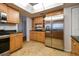 Modern kitchen featuring stainless steel appliances and ample wood cabinetry at 11114 Lake Sassa Dr, Thonotosassa, FL 33592