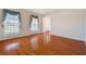 Living room with hardwood floors and large windows offering plenty of natural light at 11114 Lake Sassa Dr, Thonotosassa, FL 33592