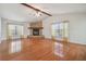 Living room with hardwood floors, stone fireplace, and vaulted ceiling at 11114 Lake Sassa Dr, Thonotosassa, FL 33592