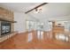 Spacious living room with hardwood floors, stone fireplace and access to patio at 11114 Lake Sassa Dr, Thonotosassa, FL 33592
