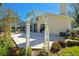 Charming patio with a white arbor and lush landscaping at 11114 Lake Sassa Dr, Thonotosassa, FL 33592