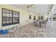 Covered patio adjacent to the pool, featuring a table and chairs at 11114 Lake Sassa Dr, Thonotosassa, FL 33592
