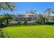 Inviting pool and screened enclosure with expansive lawn at 11114 Lake Sassa Dr, Thonotosassa, FL 33592