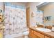 Bathroom with wood cabinets and a shower/tub combo at 11302 Temperley Pl, Tampa, FL 33625