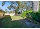 Backyard with large trees and grassy area at 116 S Hale Ave, Tampa, FL 33609