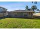 Large grassy backyard with gray house exterior at 116 S Hale Ave, Tampa, FL 33609